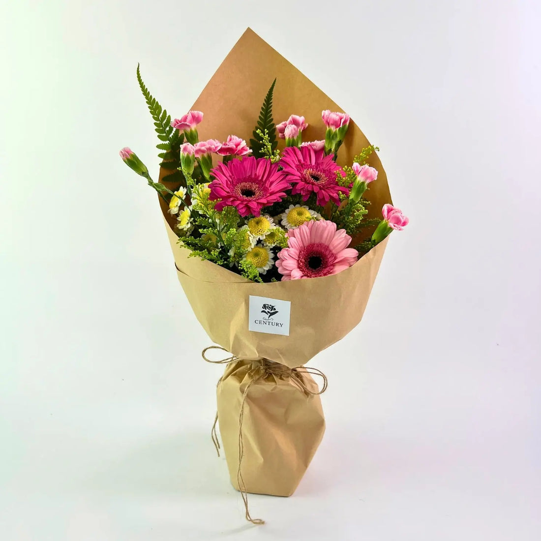 Juwita Bouquet from Century Flower Bunga Kita Collection with pink gerberas and spray carnations in a rustic kraft wrap.