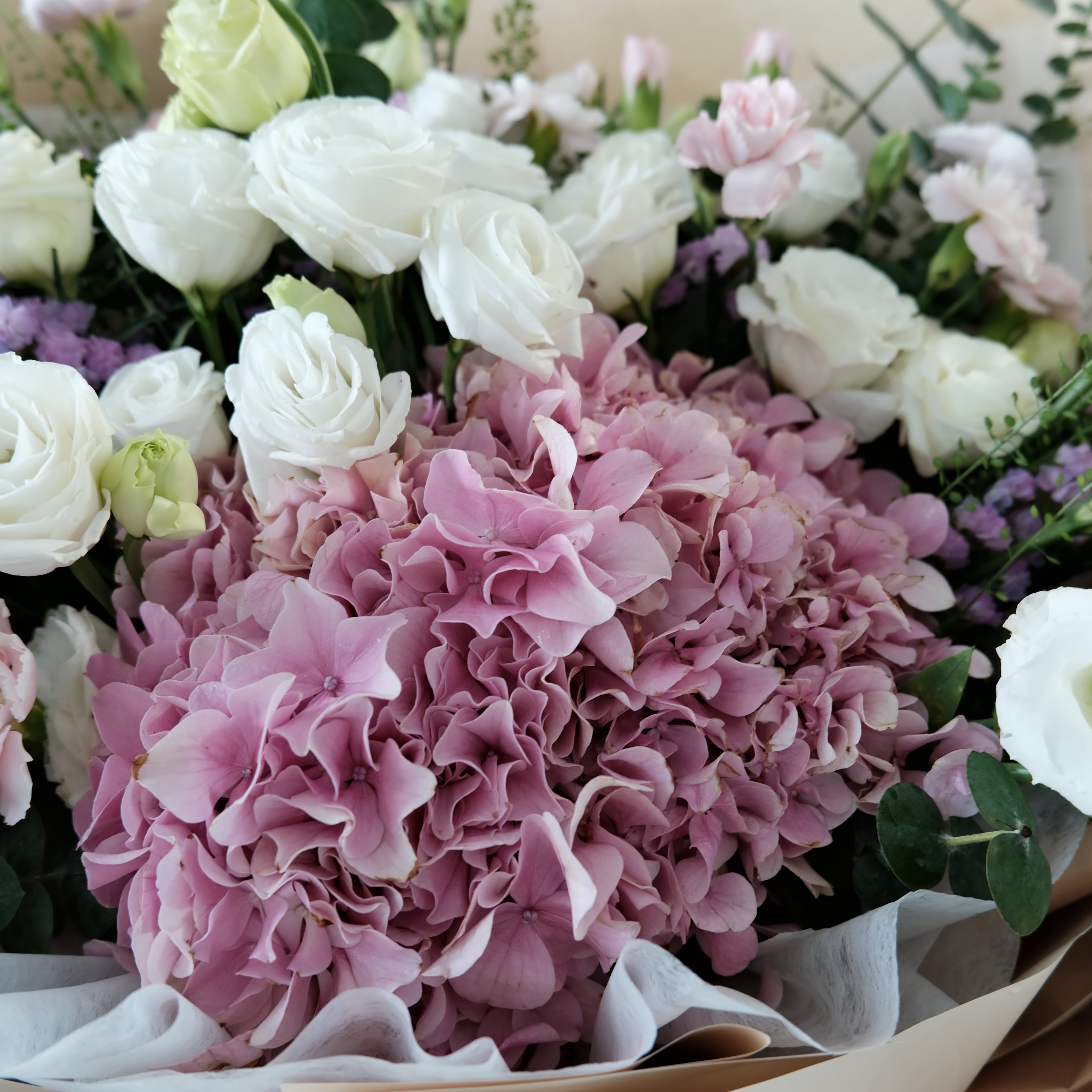 Bouquet of pink and white flowers with greenery