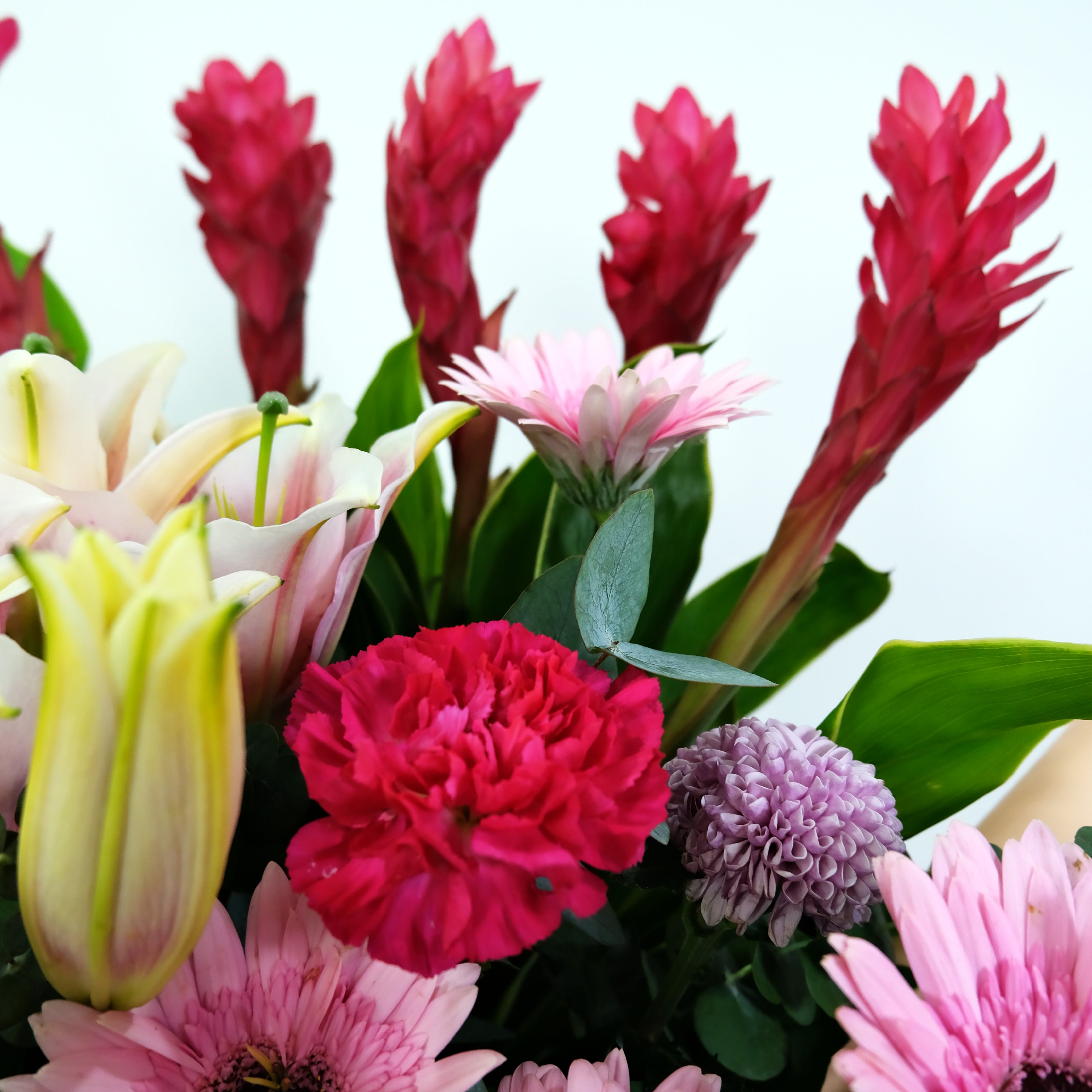 Bouquet of colorful flowers including pink, red, and green.