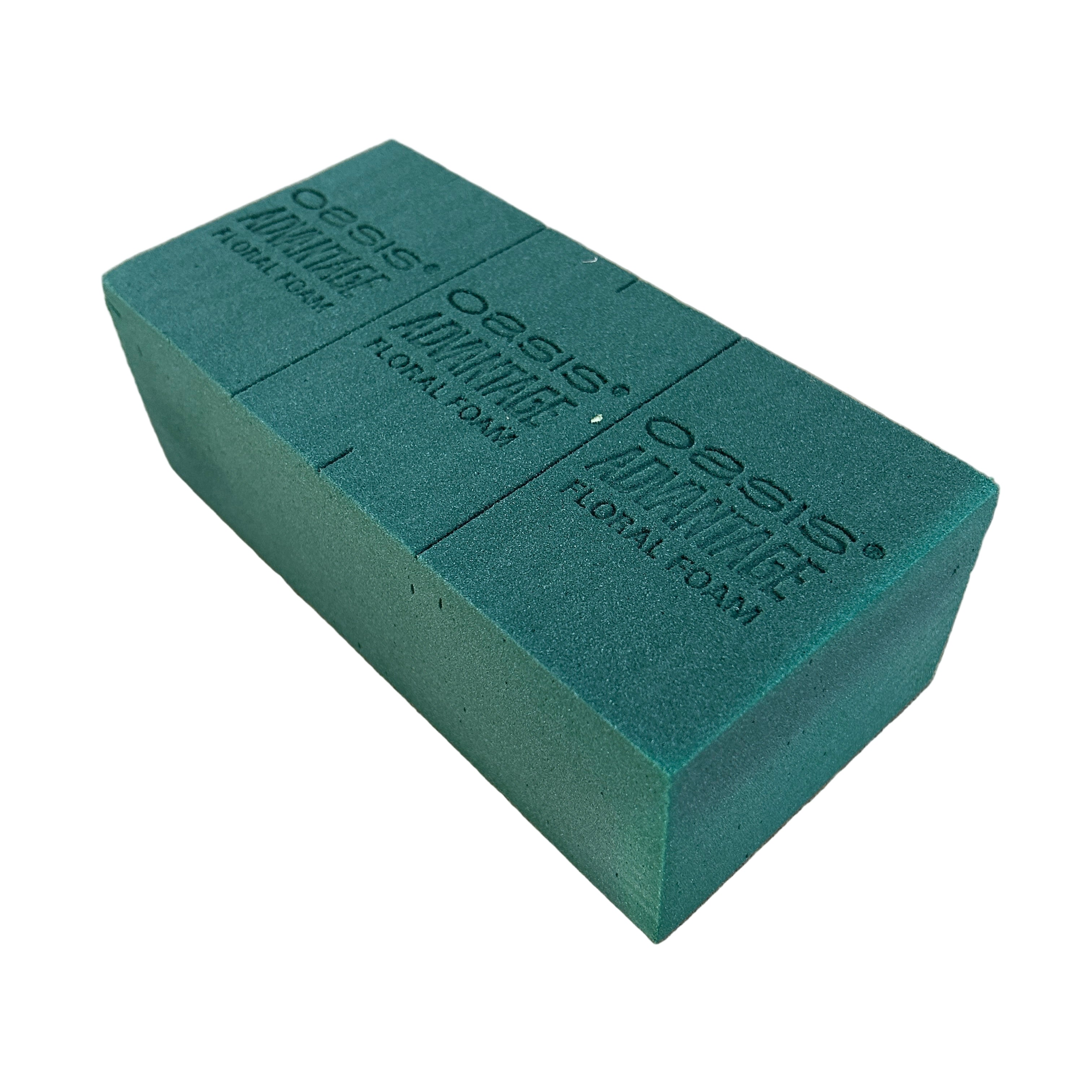 Green floral foam block on a concrete surface