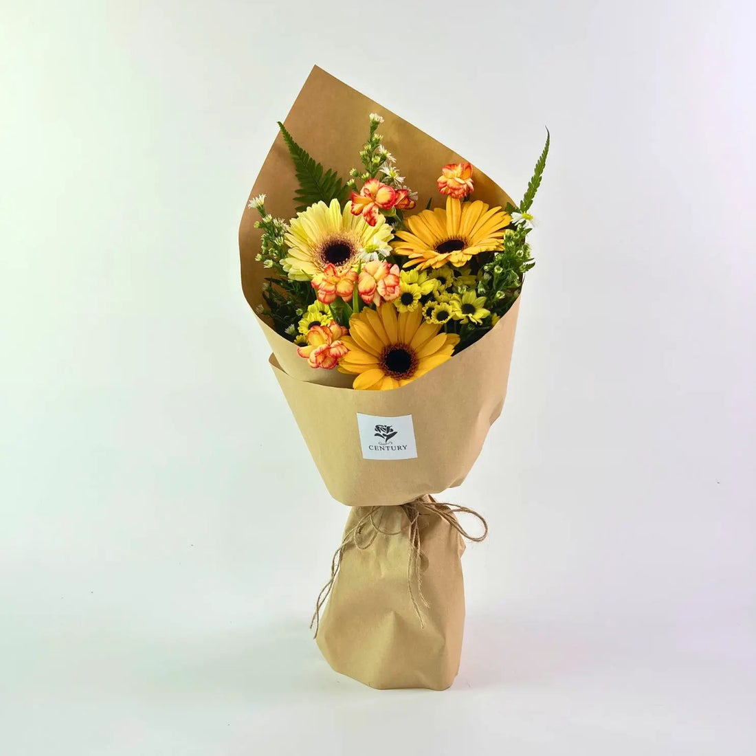 Mentari Bouquet from Century Flower Bunga Kita Collection with yellow gerberas and orange carnations in a rustic kraft wrap.