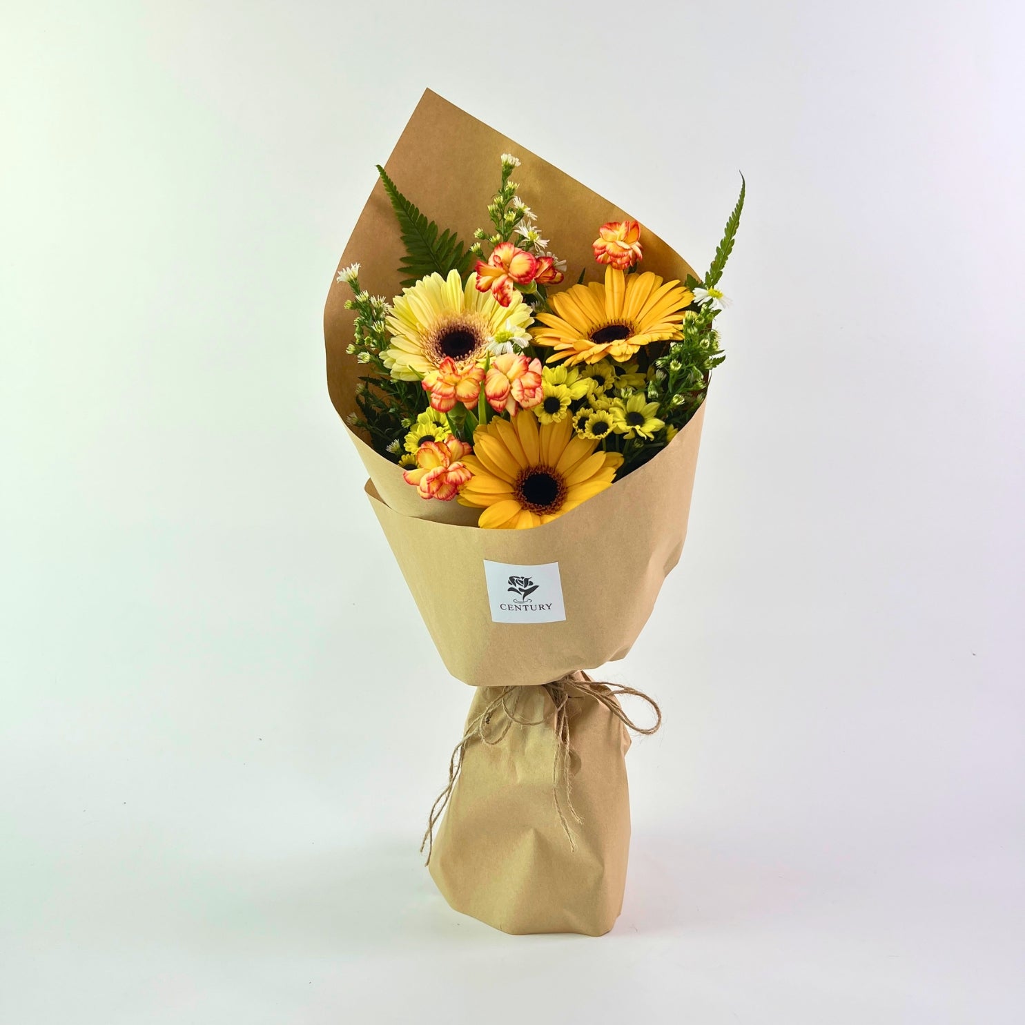 Mentari Bouquet from Century Flower Bunga Kita Collection with yellow gerberas and orange carnations in a rustic kraft wrap.
