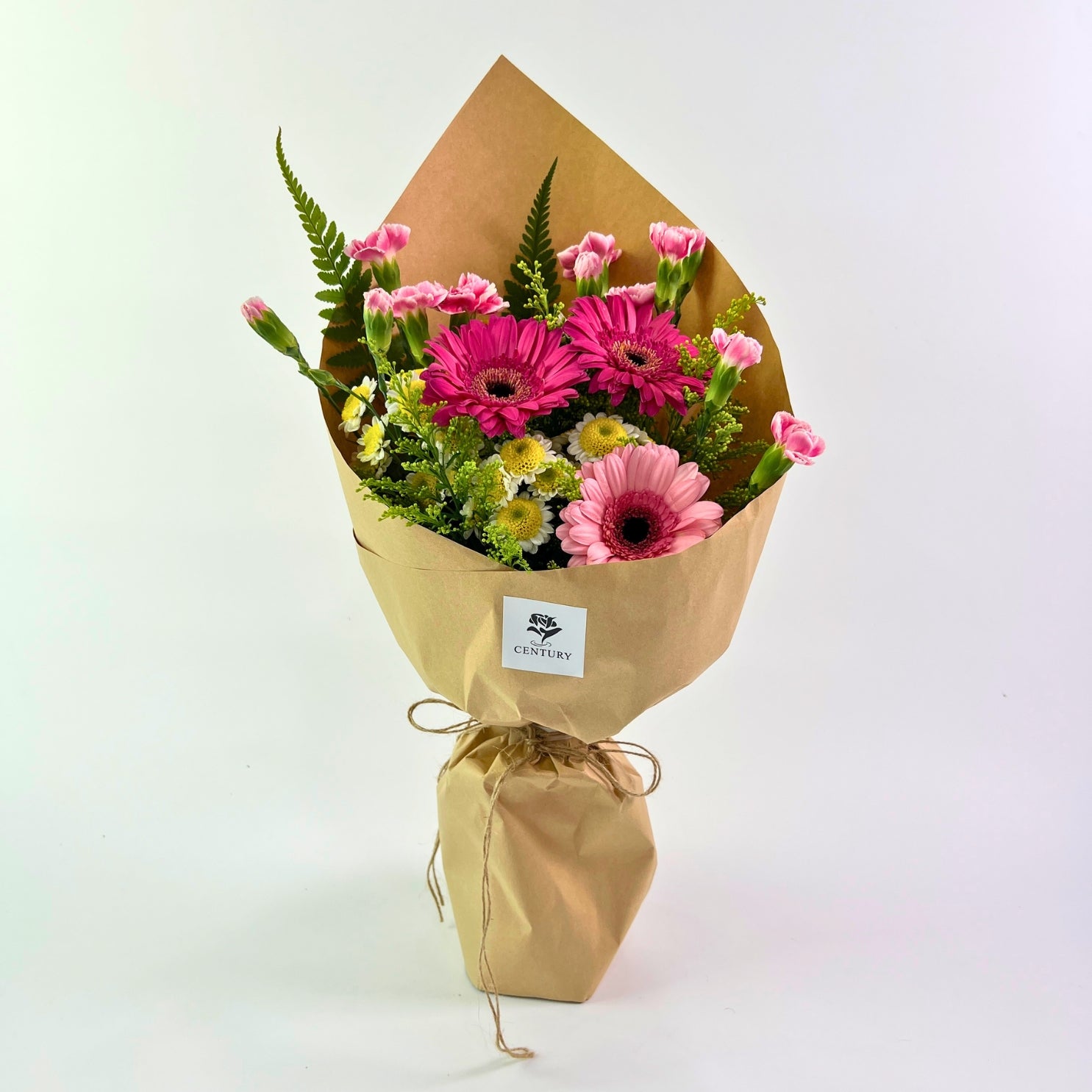 Juwita Bouquet from Century Flower Bunga Kita Collection with pink gerberas and spray carnations in a rustic kraft wrap.