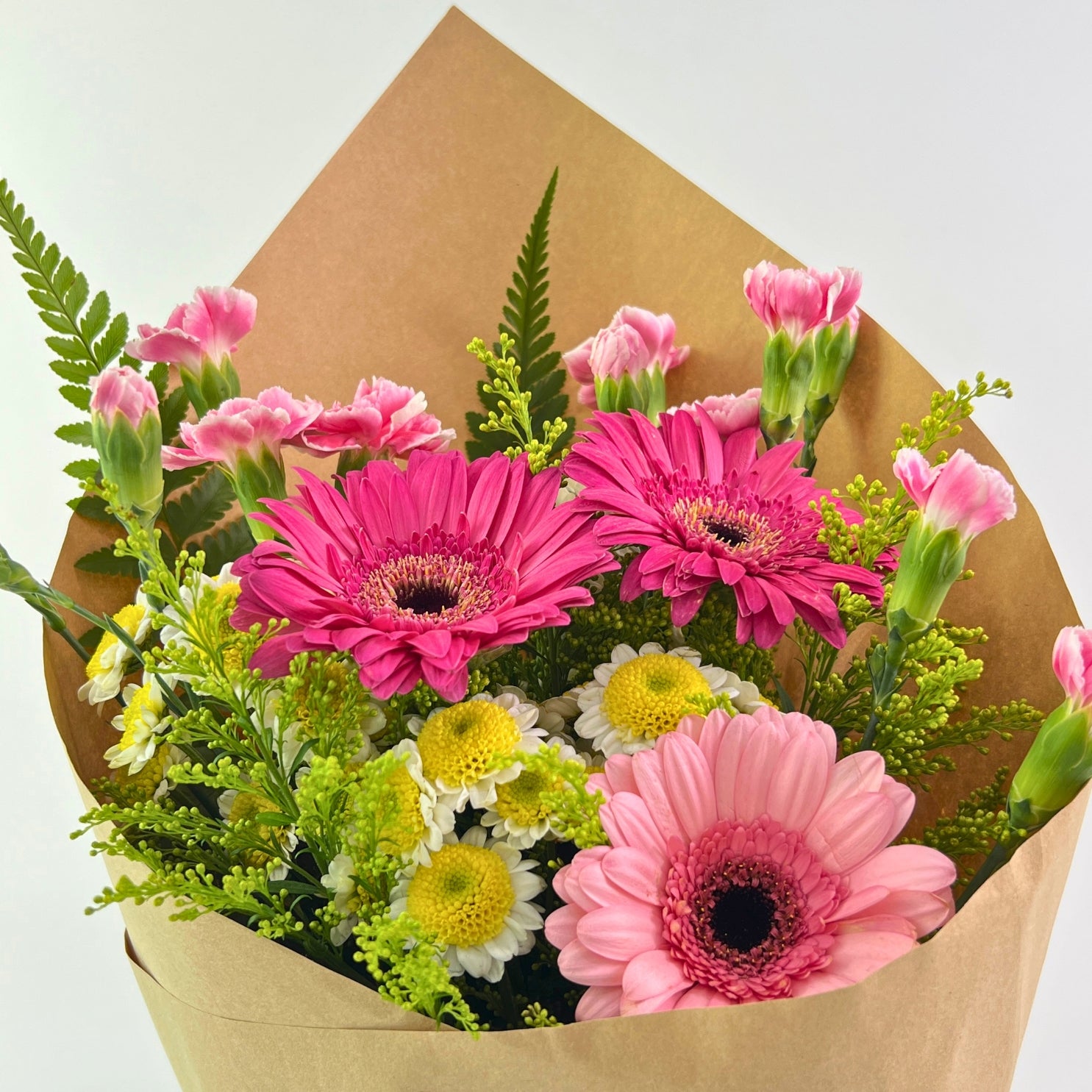 Juwita Bouquet from Century Flower Bunga Kita Collection with pink gerberas and spray carnations in a rustic kraft wrap.