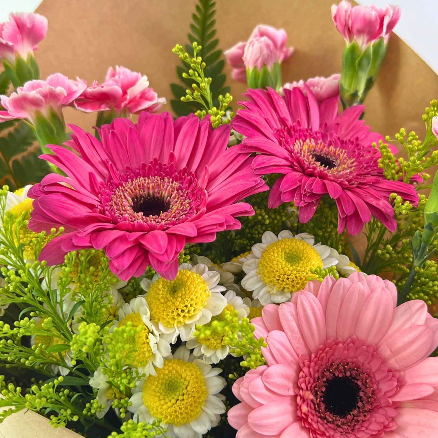 Juwita Bouquet from Century Flower Bunga Kita Collection with pink gerberas and spray carnations in a rustic kraft wrap.