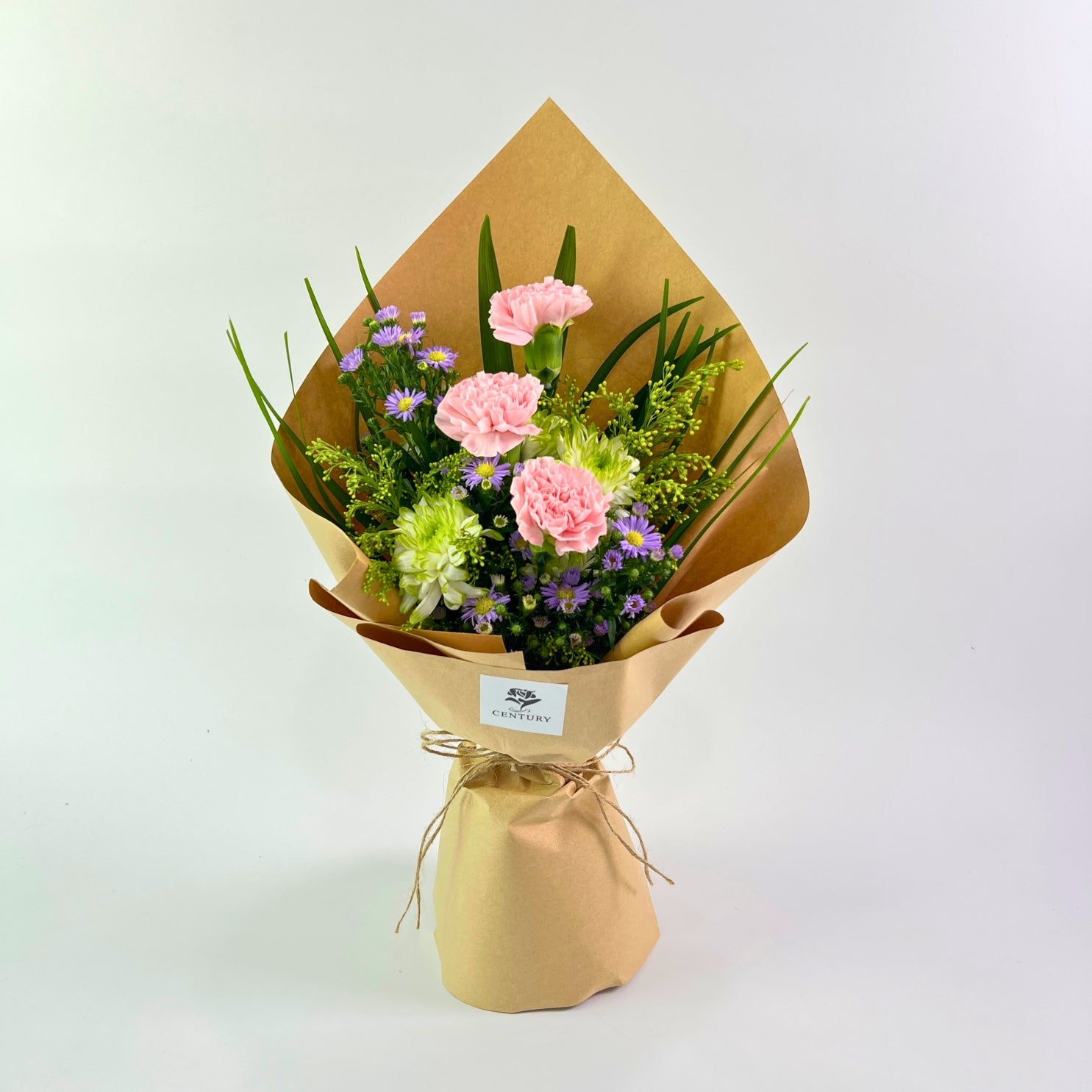 Adinda Bouquet from Century Flower Bunga Kita Collection with pink carnations and purple asters in a rustic kraft wrap.