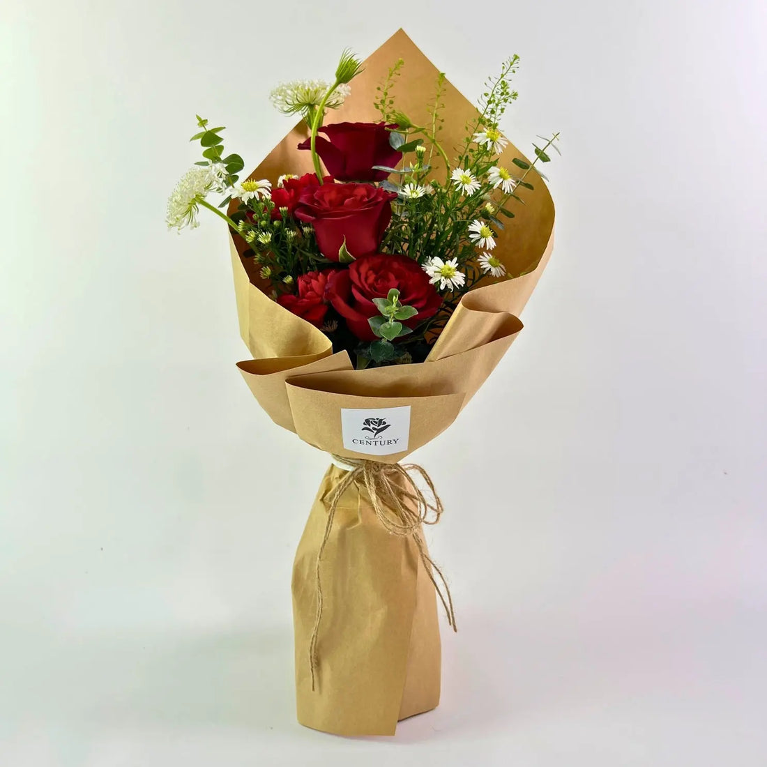 Kasih Bouquet from Century Flower Bunga Kita Collection with red roses and wild chamomile in a rustic kraft wrap.