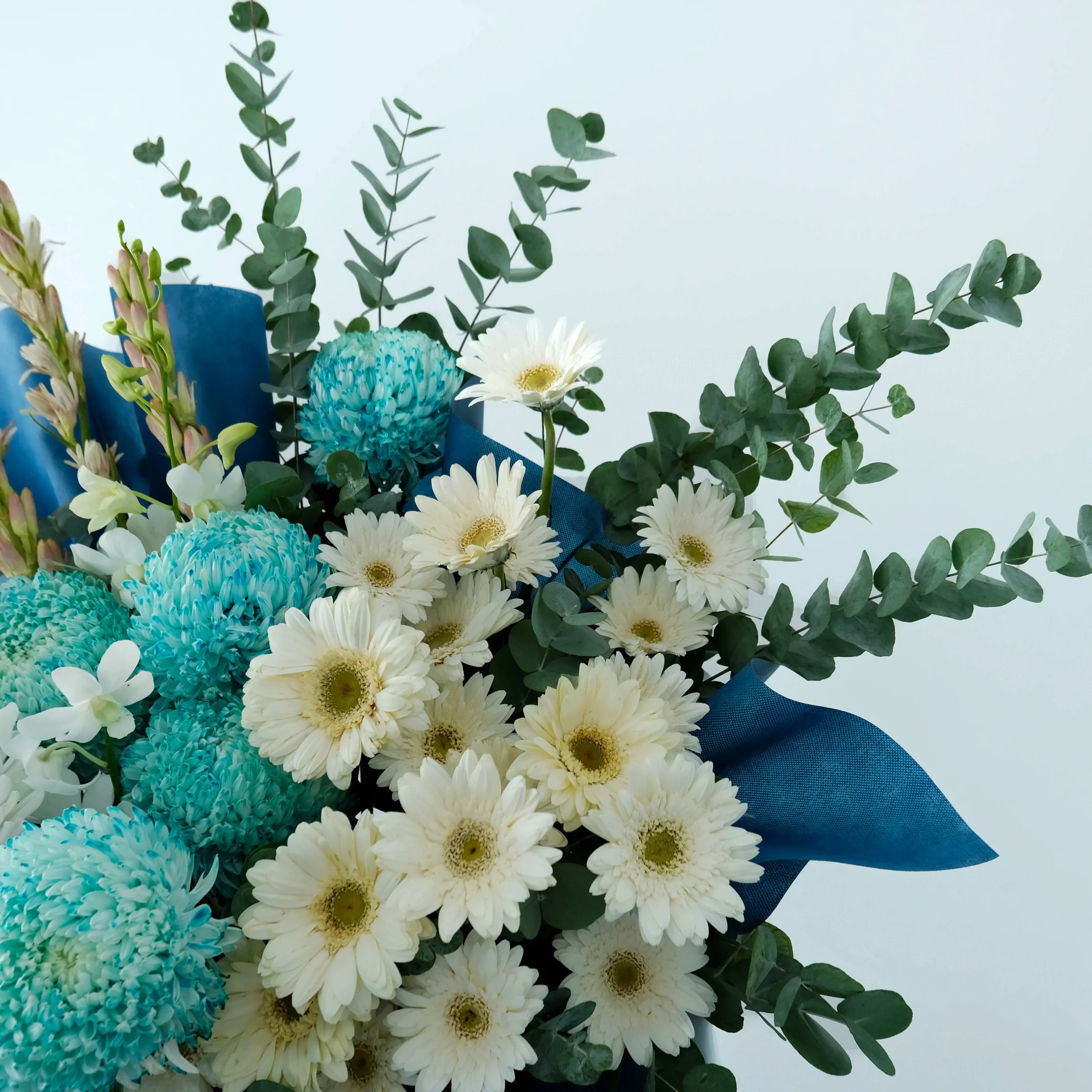 Bouquet of flowers with blue and white flowers on a light blue background
