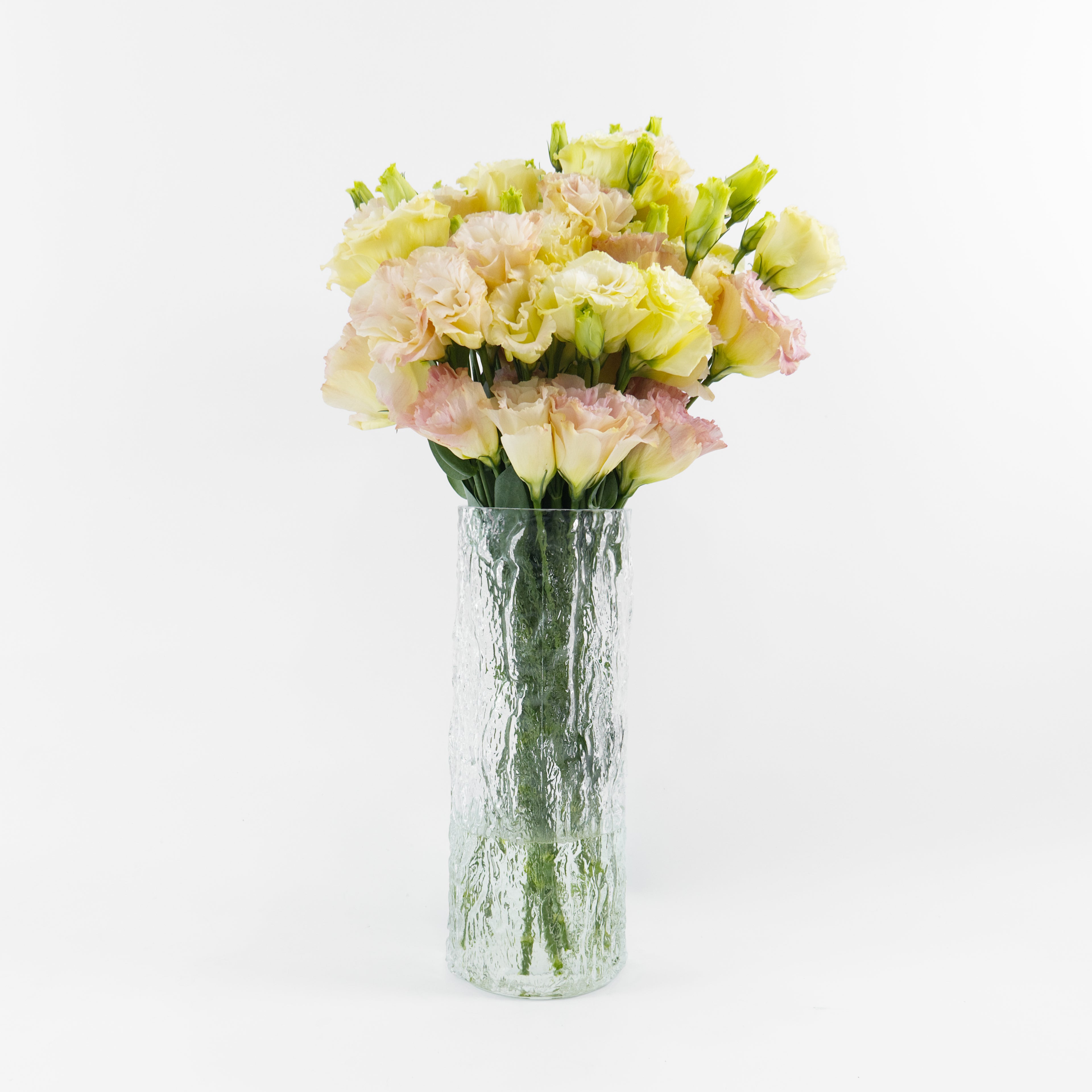 Bundles of wholesale ruffled peach Lisianthus flowers kept in clean water containers inside a floral cold storage facility in Kuala Lumpur.