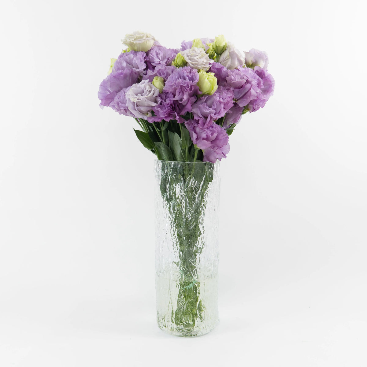 Bundles of wholesale ruffled lavender Lisianthus flowers kept in clean water containers inside a floral cold storage facility in Kuala Lumpur.