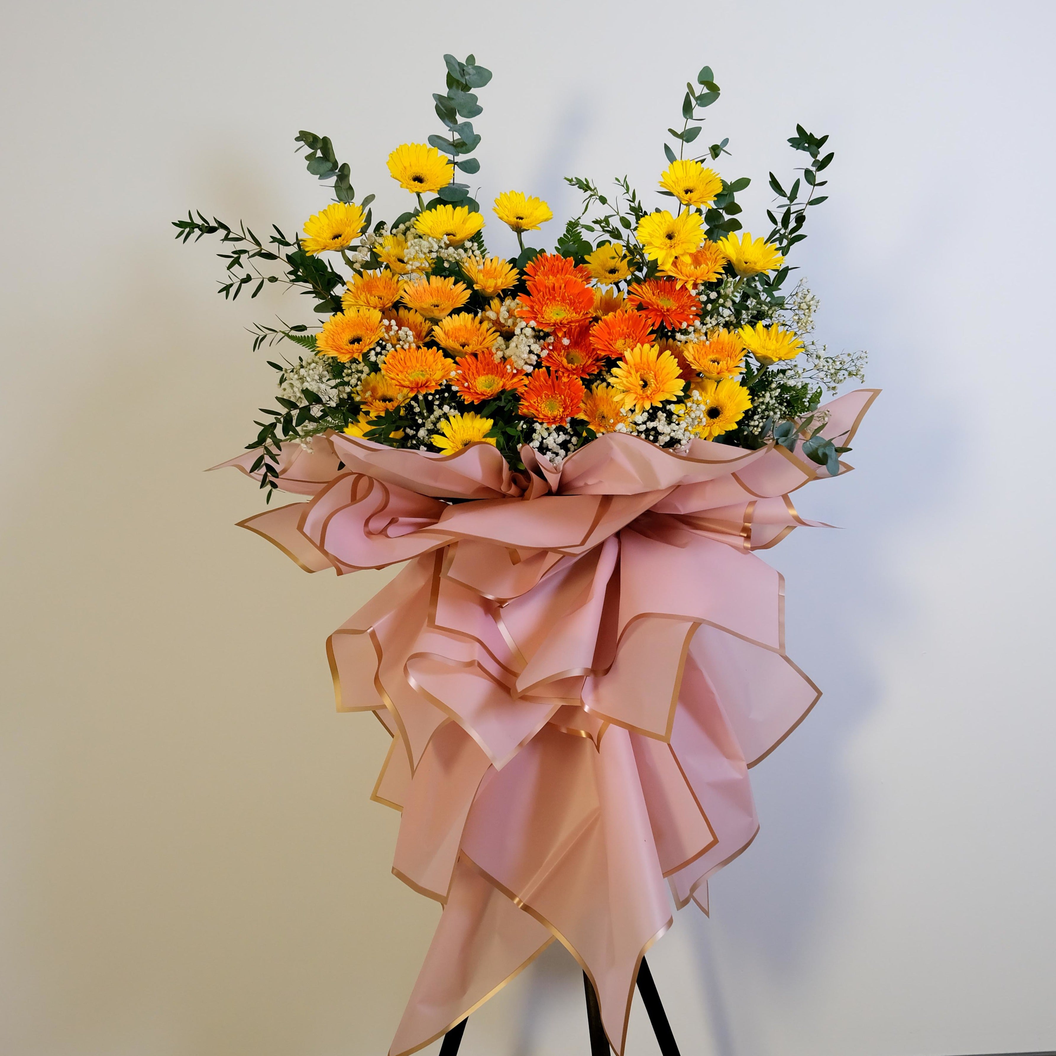 Bouquet of flowers with a pink ribbon on a light background