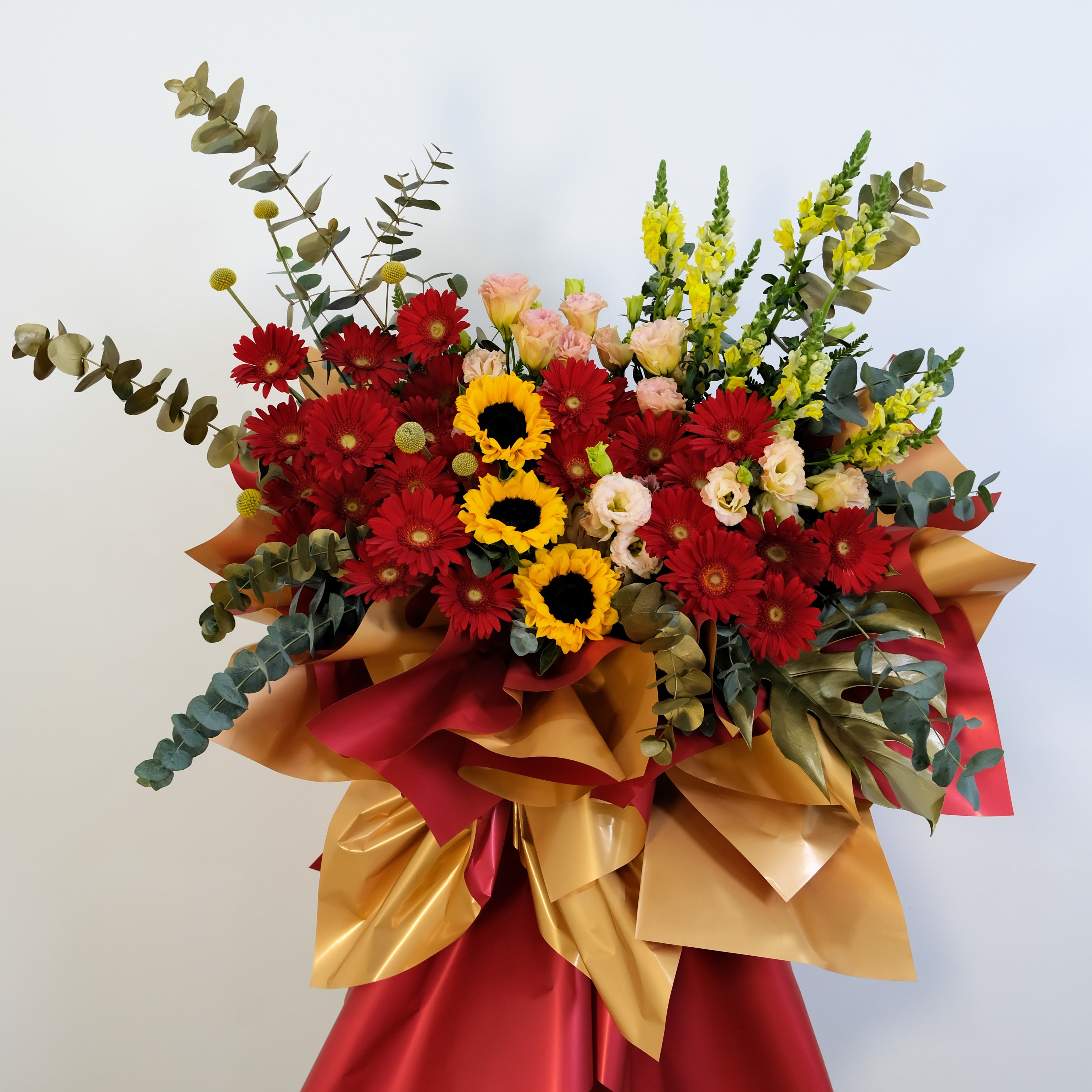 Bouquet of flowers with red, yellow, and green colors on a white background