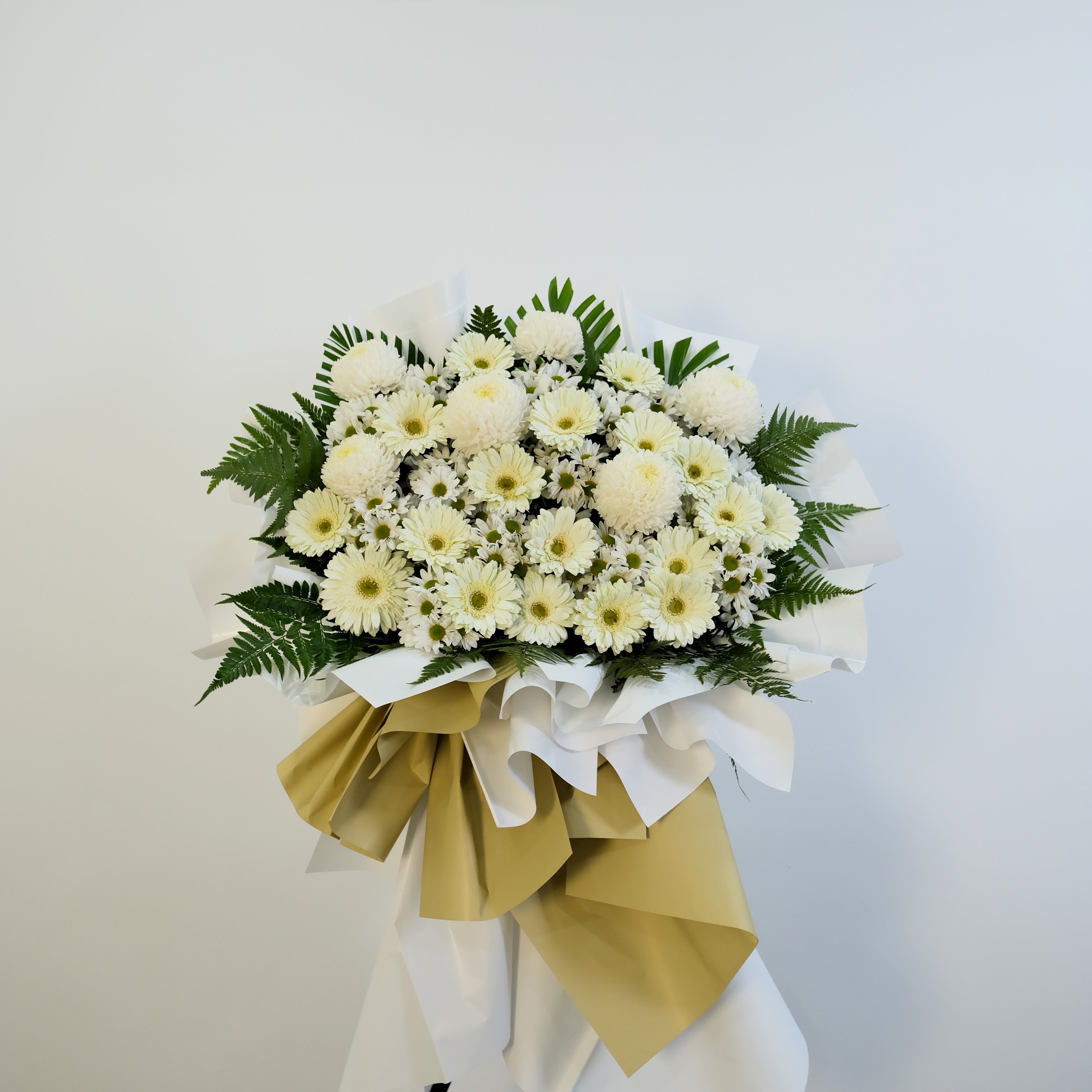 Bouquet of white flowers with greenery on a white background