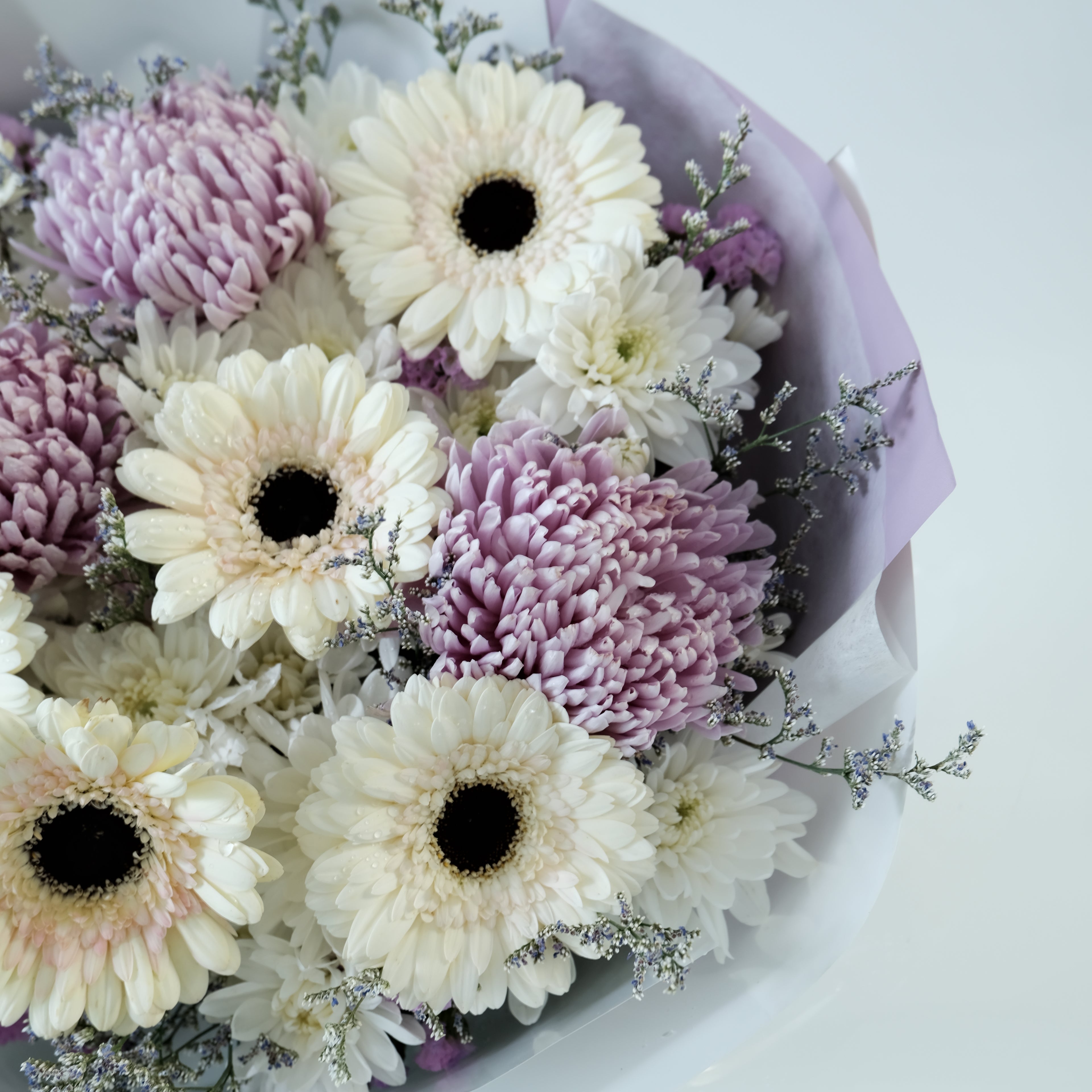 Bouquet of white and purple flowers on a white background