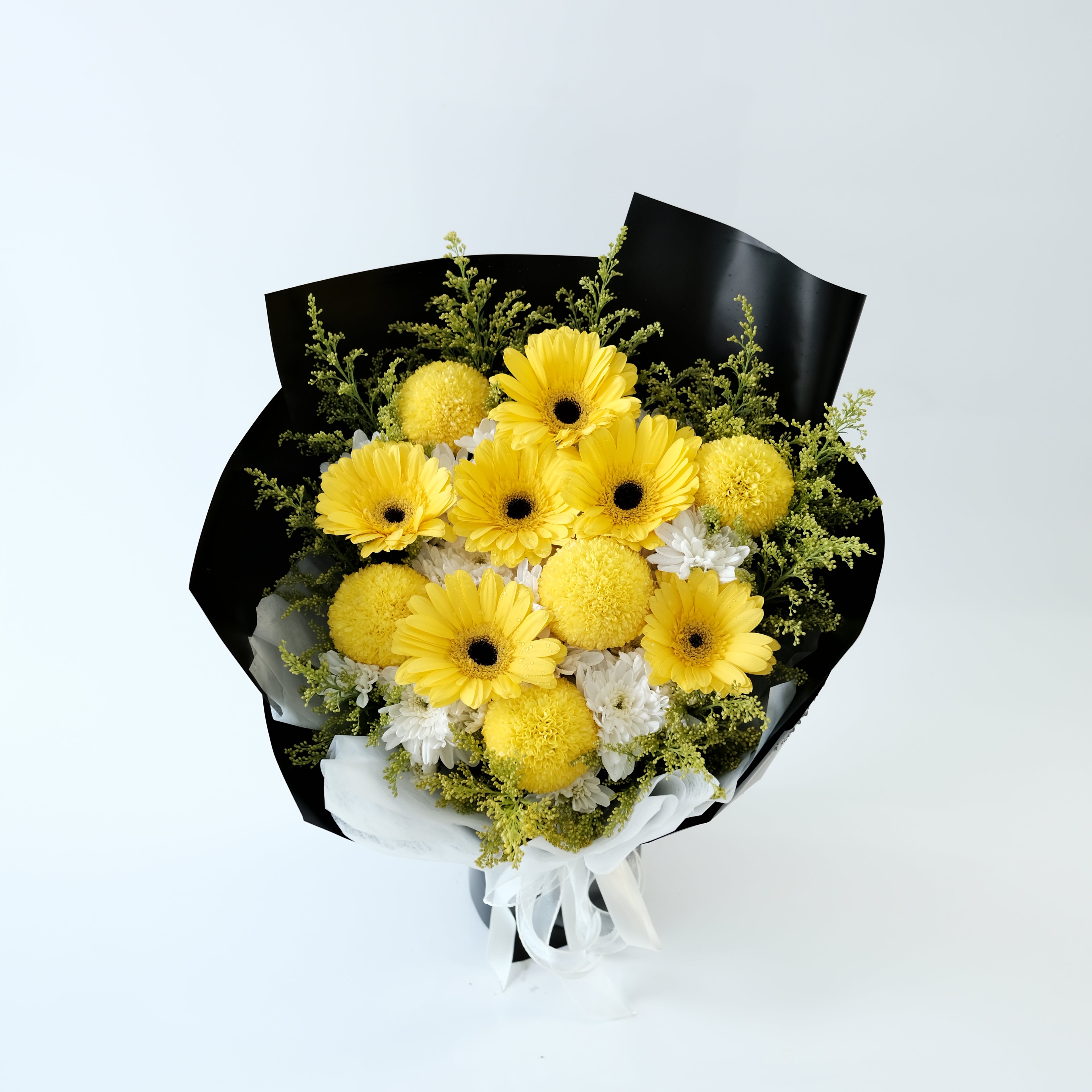 Bouquet of yellow flowers wrapped in black paper on a light gray background