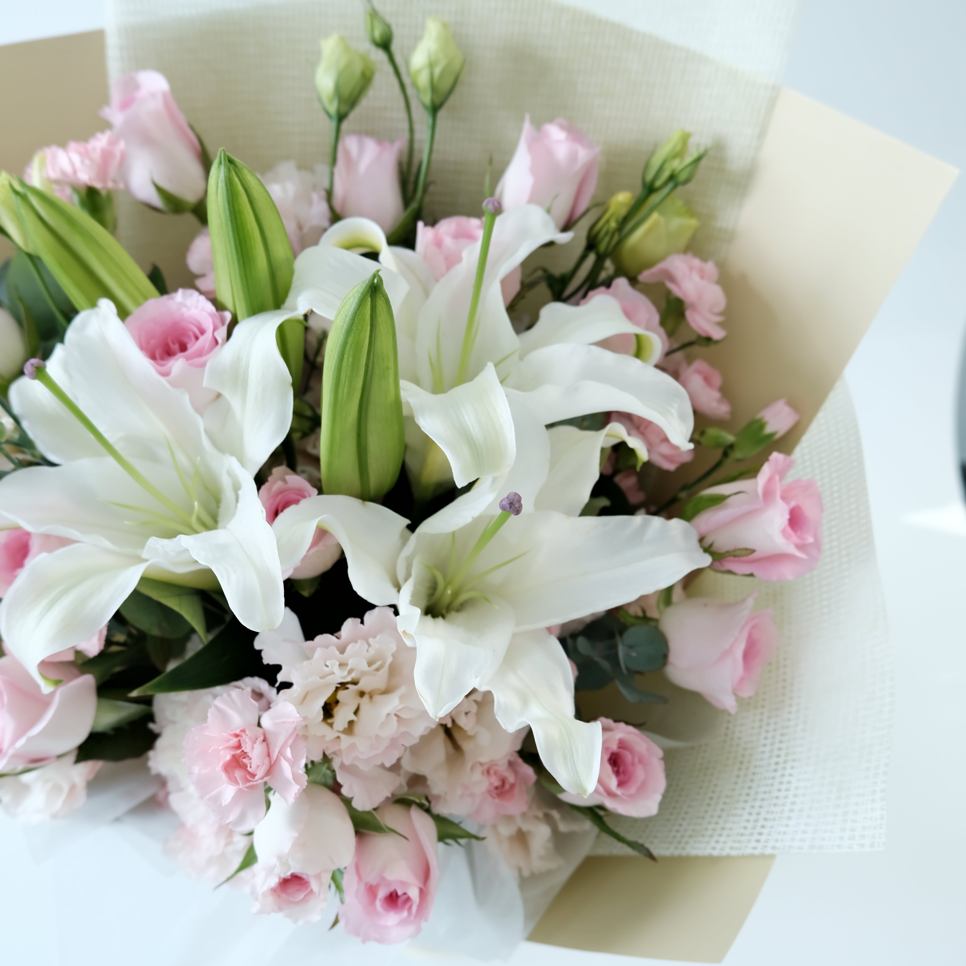 Bouquet of white and pink flowers on a light background