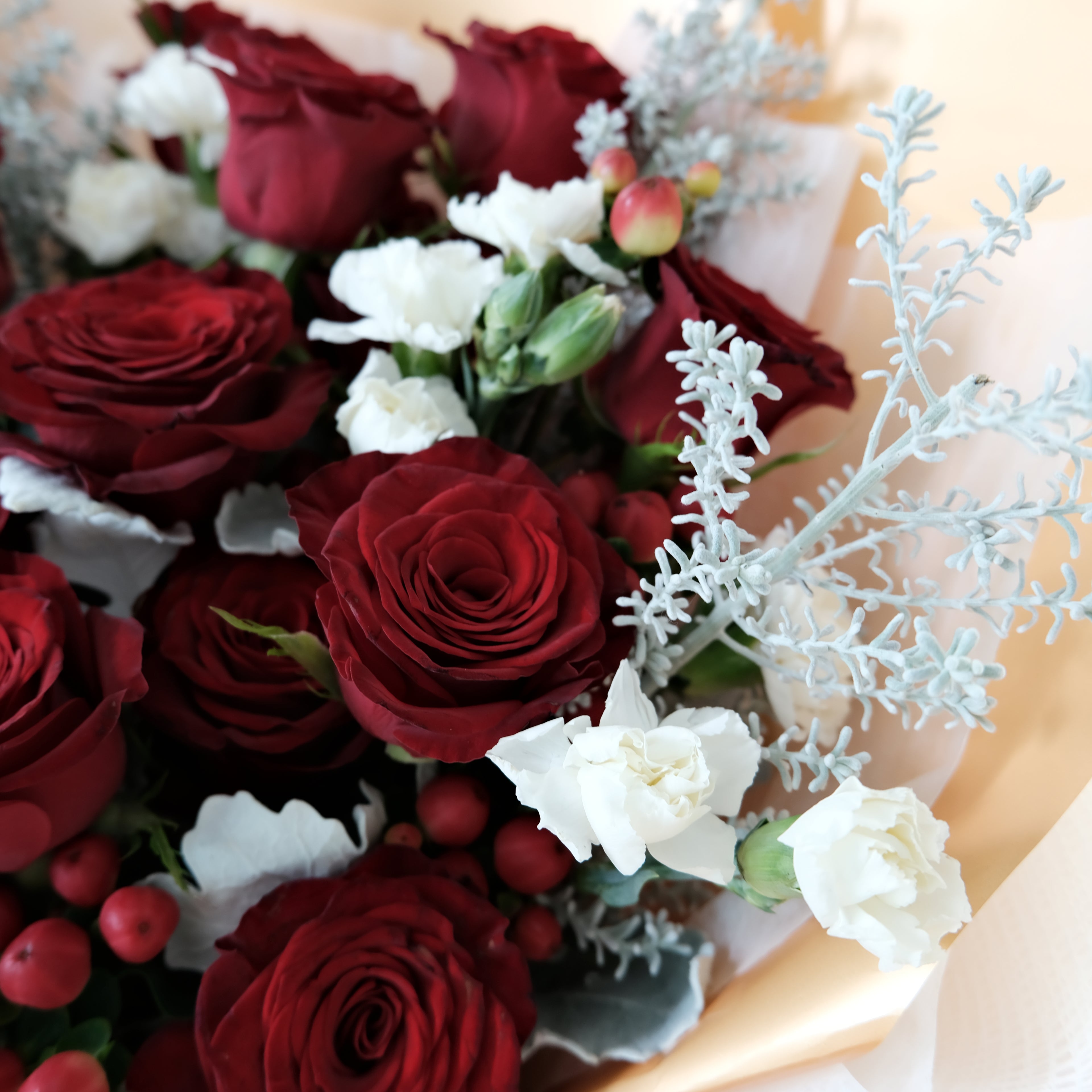 Bouquet of red and white flowers with a gold base