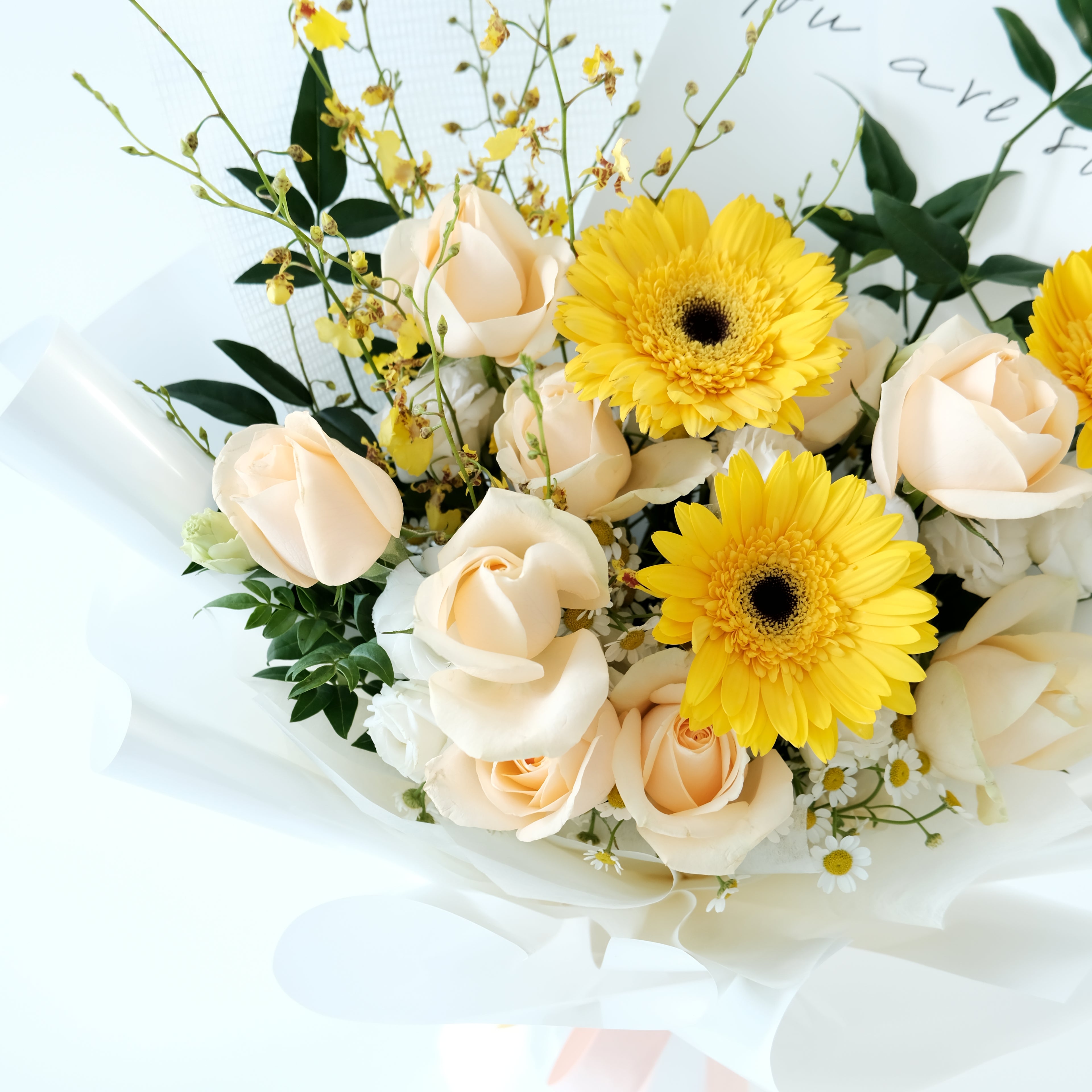 Bouquet of flowers with yellow daisies and white roses on a light background