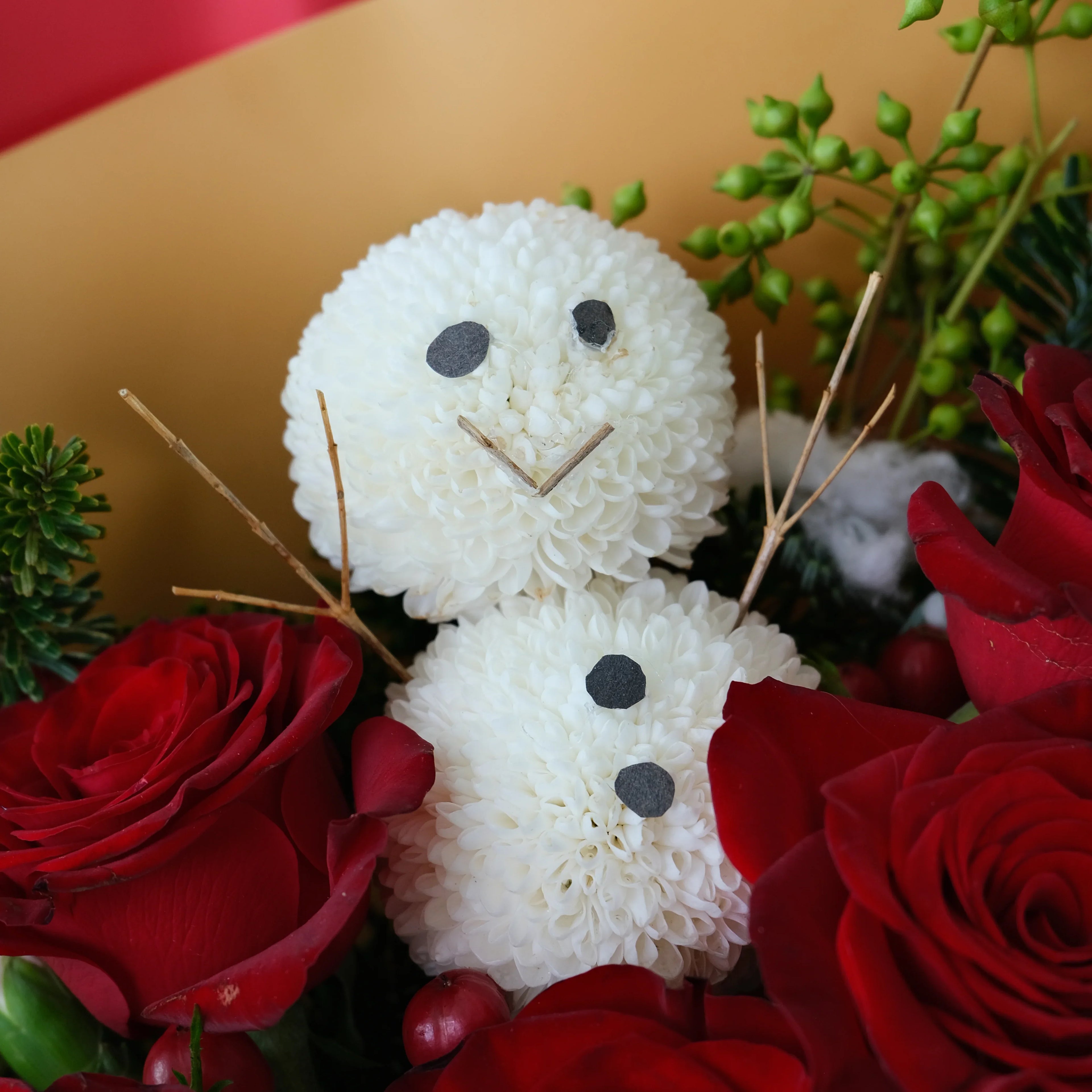 Flower snowman bouquet with white chrysanthemum, red roses, and greenery