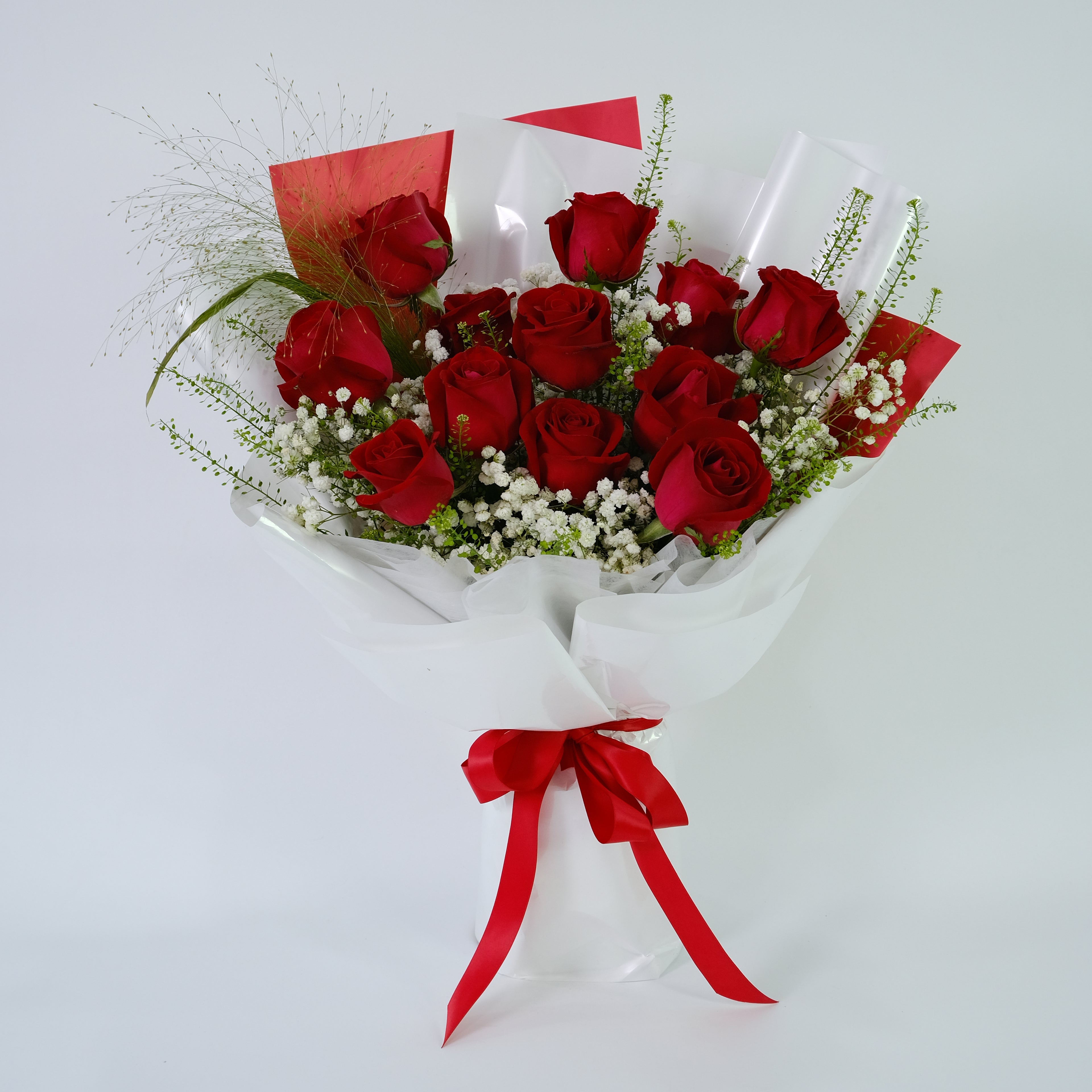 Bouquet of red roses with a red ribbon on a white background