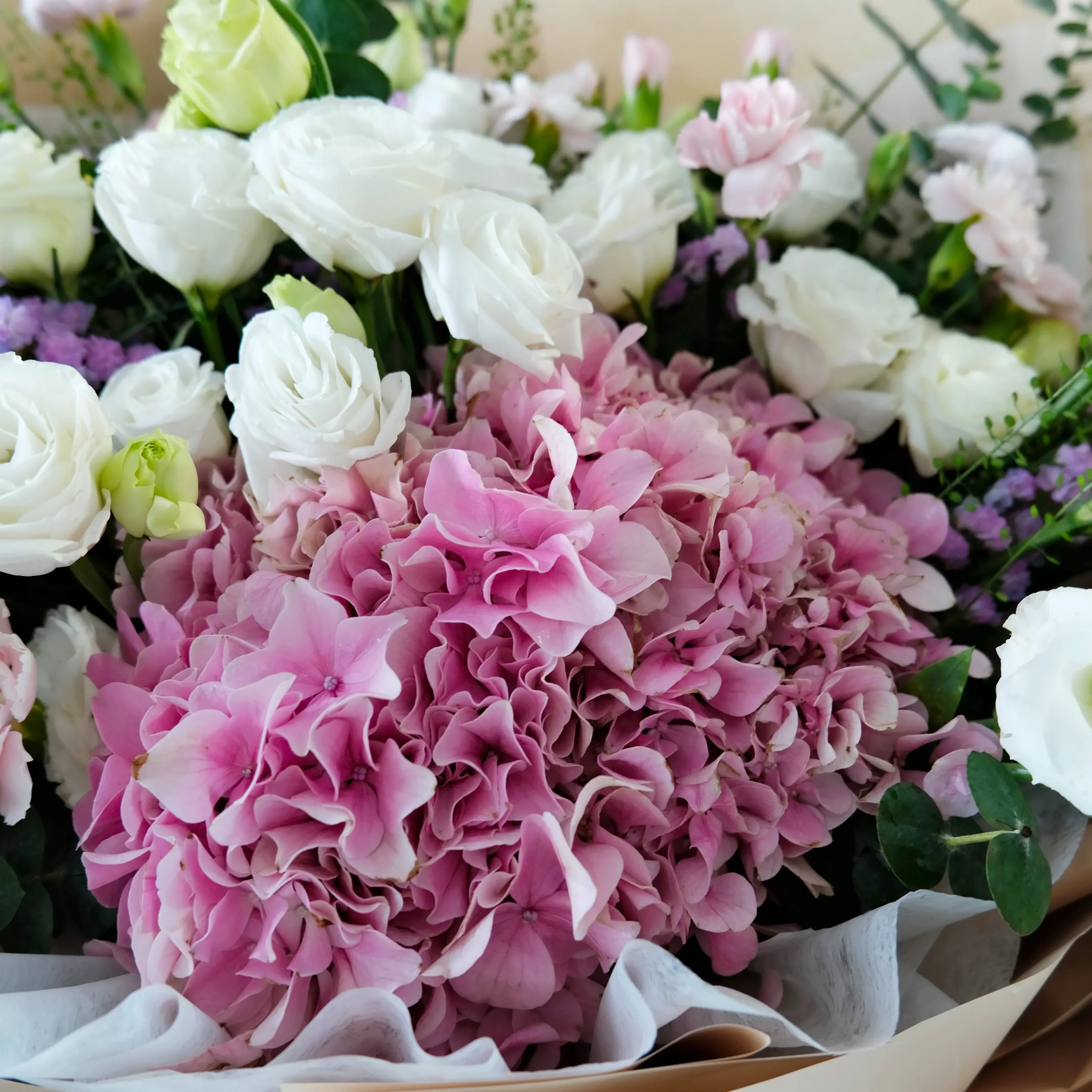 Bouquet of pink and white flowers with greenery
