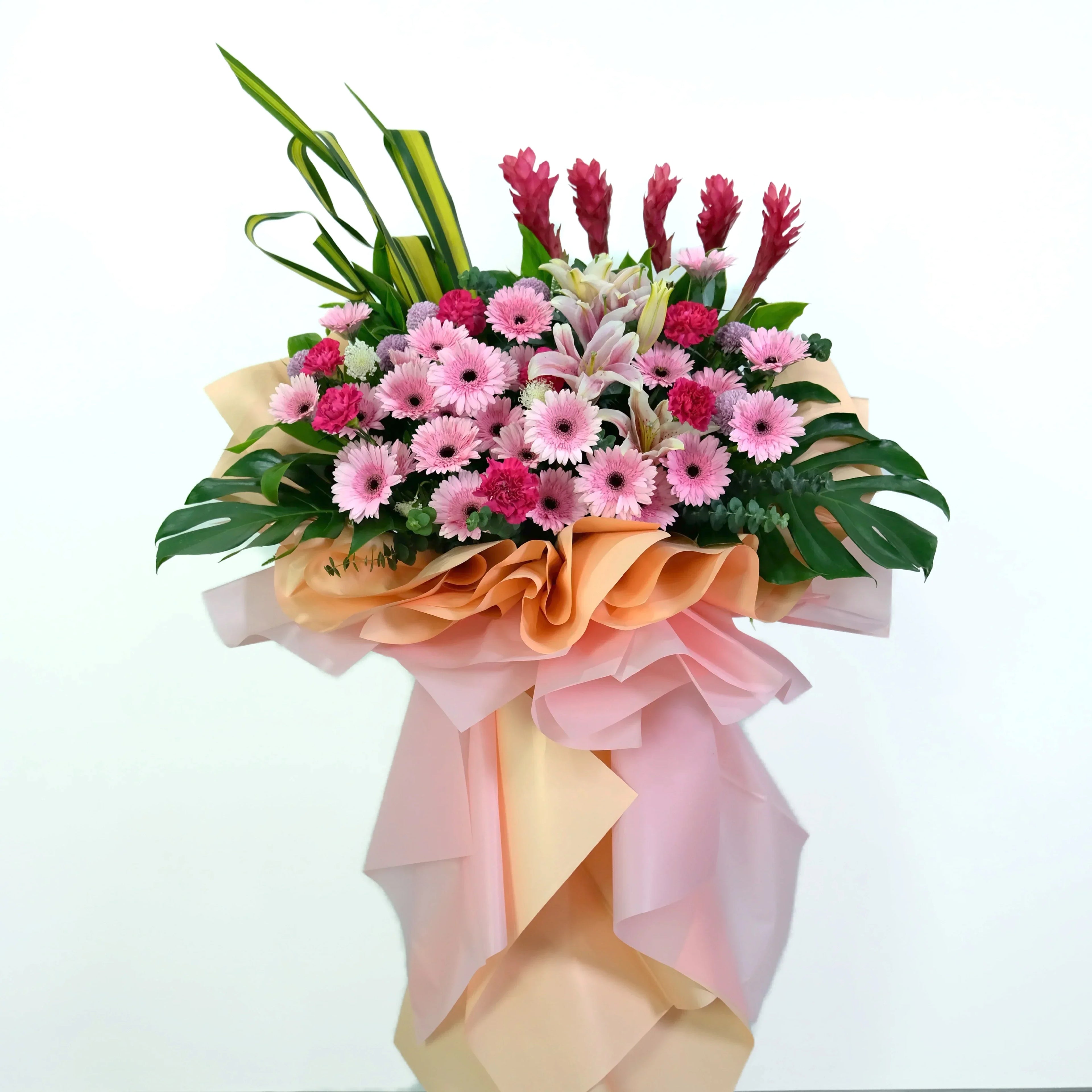 Bouquet of flowers with pink and green elements on a white background