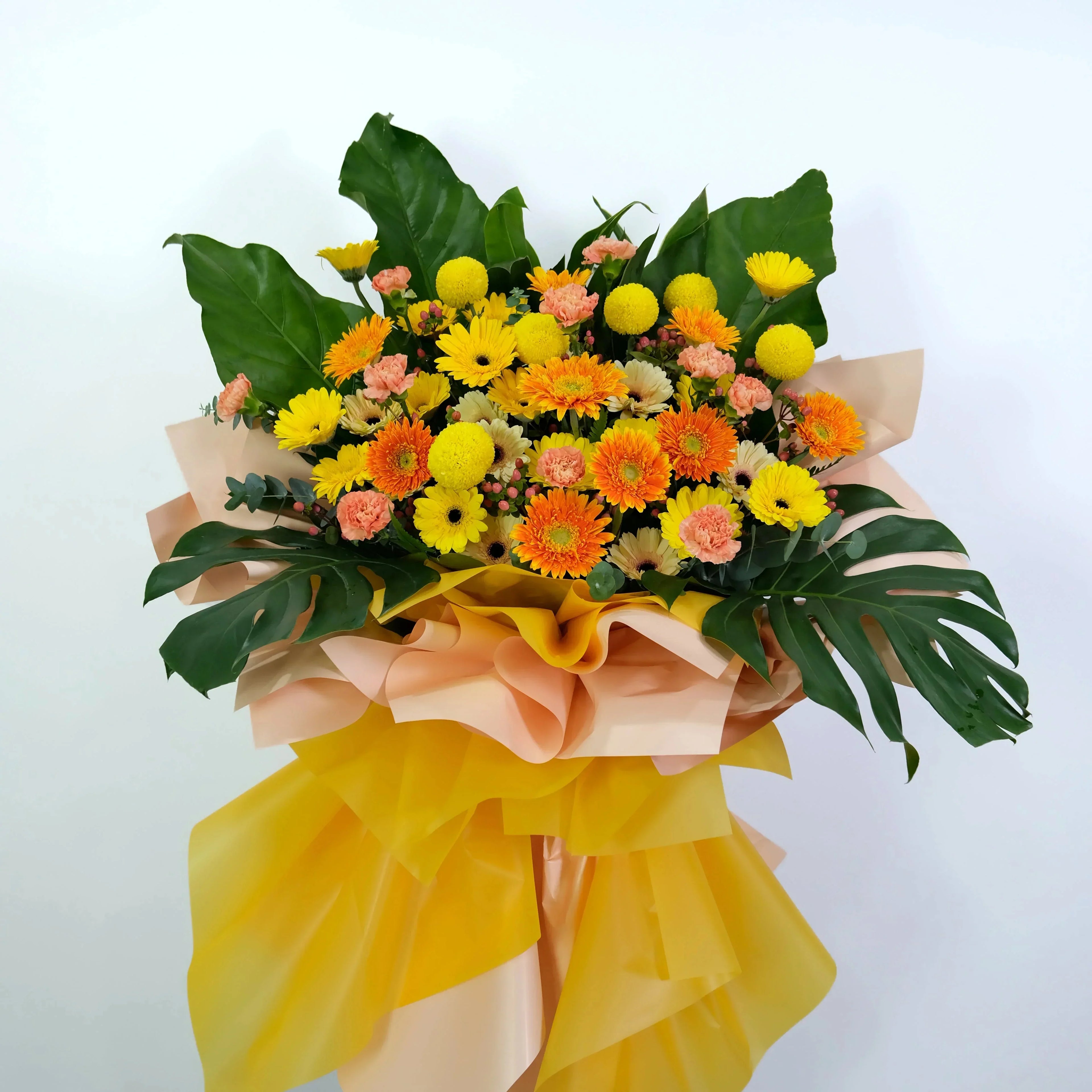 Bouquet of flowers with yellow, orange, and pink flowers on a white background