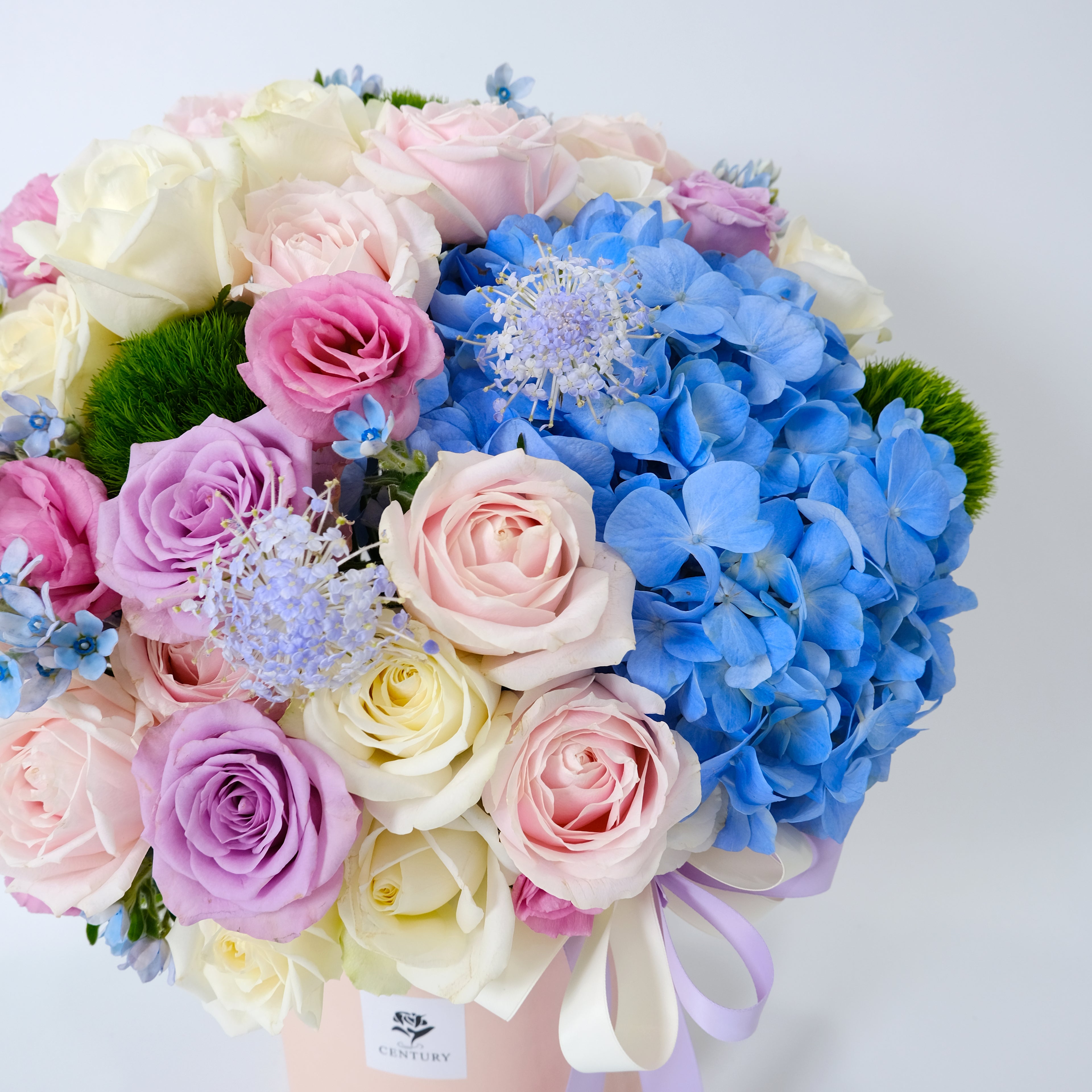 Bouquet of flowers with pink, blue, and white colors on a light gray background