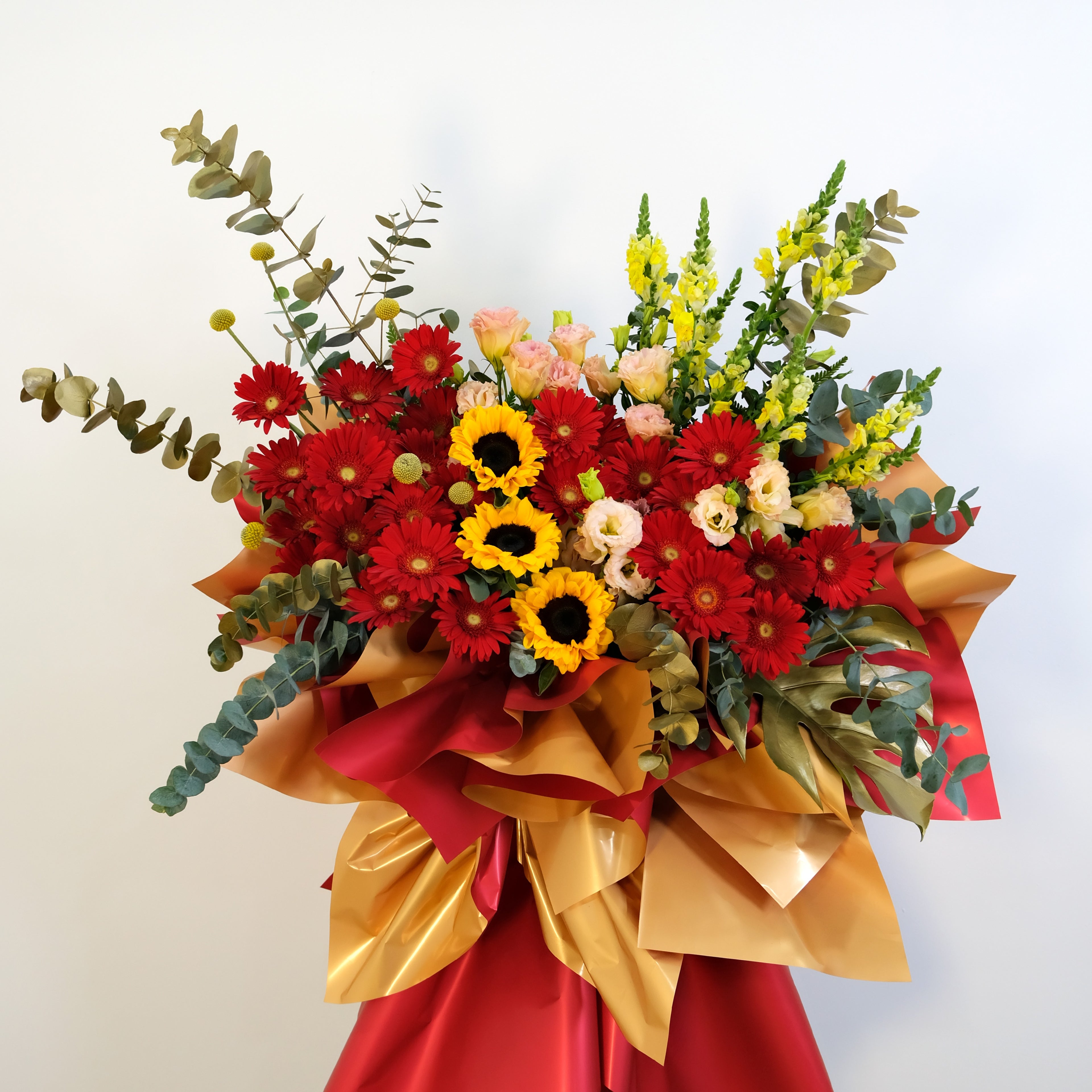 Bouquet of flowers with red, yellow, and green colors on a white background