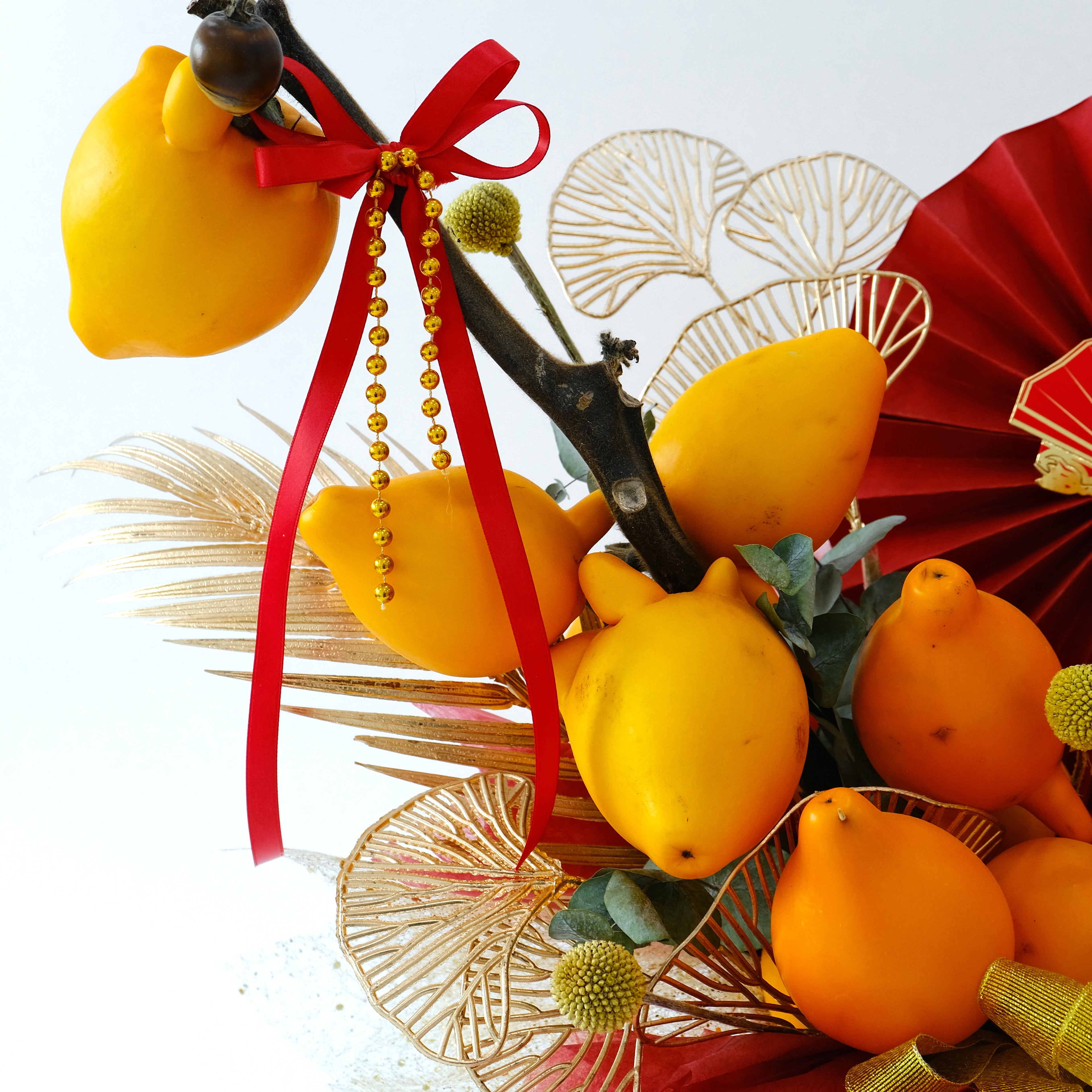 CNY Jin Yu Box with golden Solanum mammosum fruit and red Fu ornaments in a red hatbox for luxury delivery in KL.