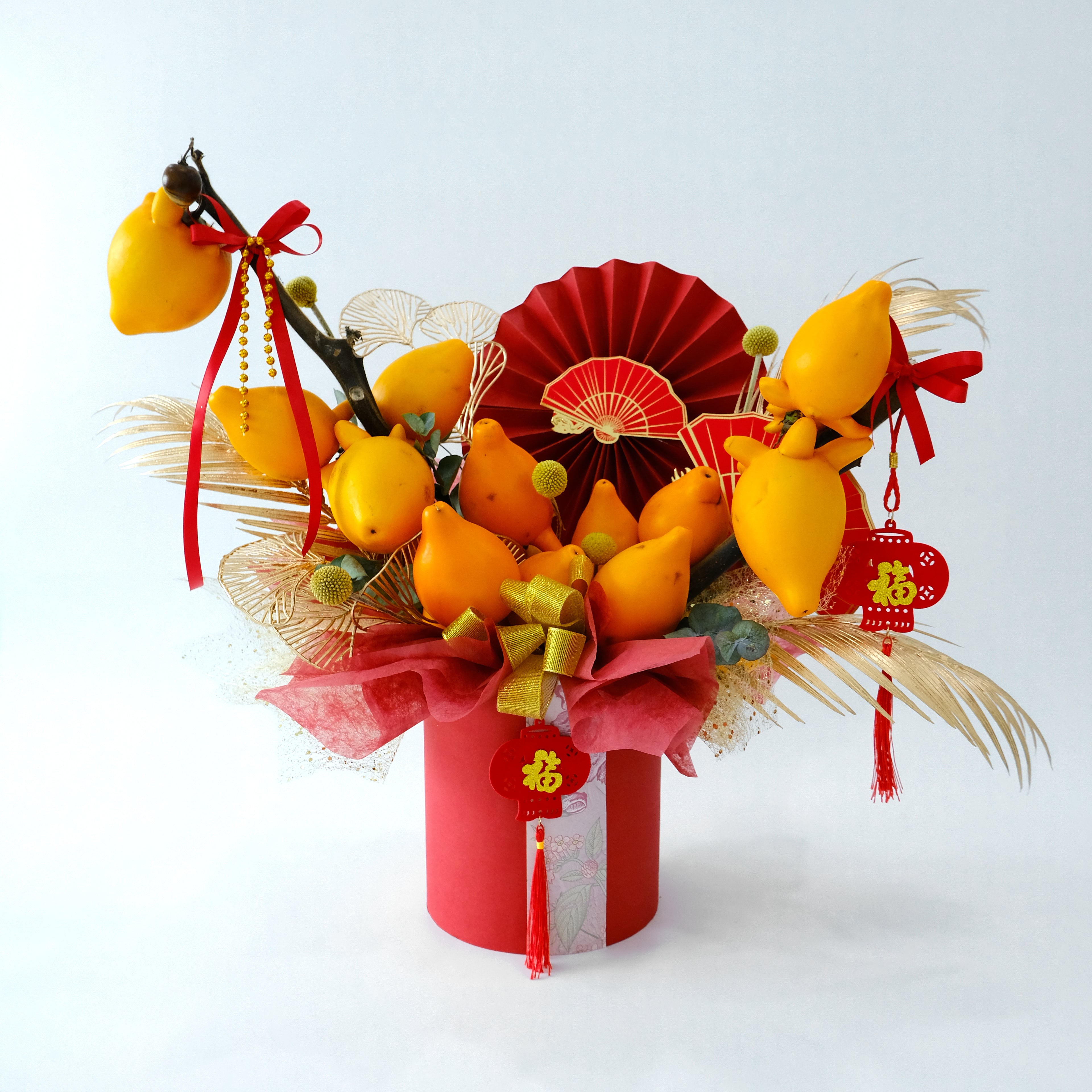 CNY Jin Yu Box with golden Solanum mammosum fruit and red Fu ornaments in a red hatbox for luxury delivery in KL.