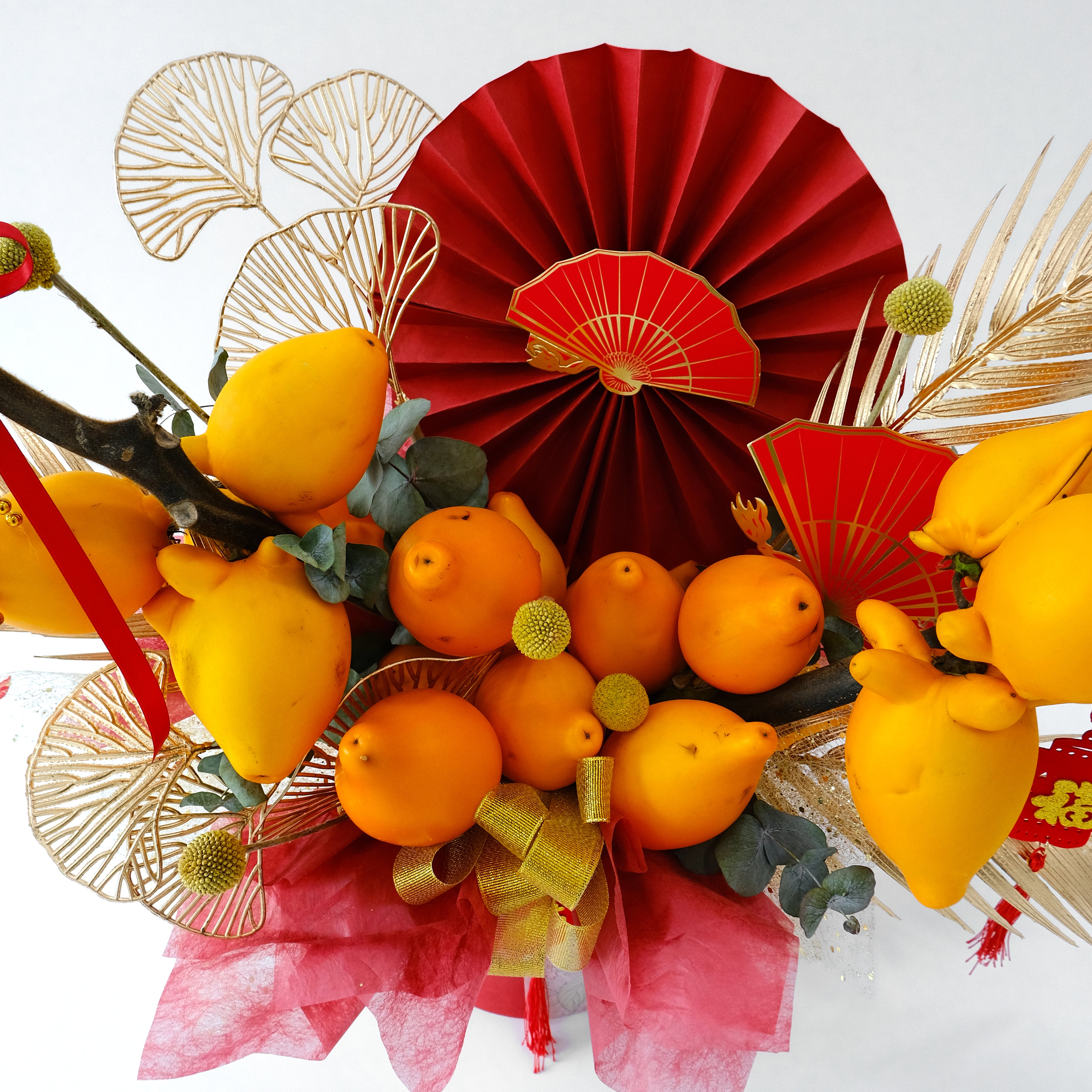 CNY Jin Yu Box with golden Solanum mammosum fruit and red Fu ornaments in a red hatbox for luxury delivery in KL.
