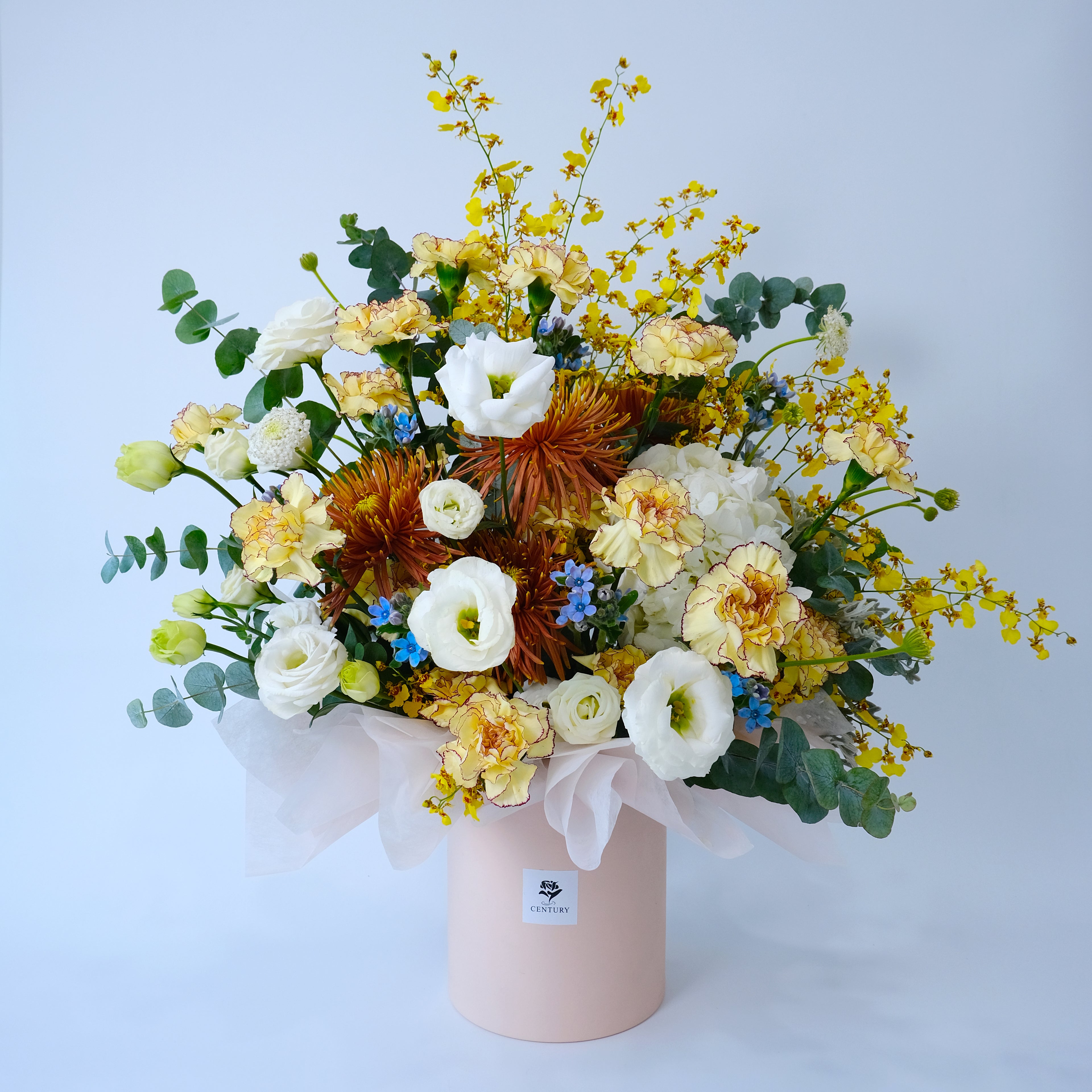 Bouquet of flowers in a pink box on a light blue background